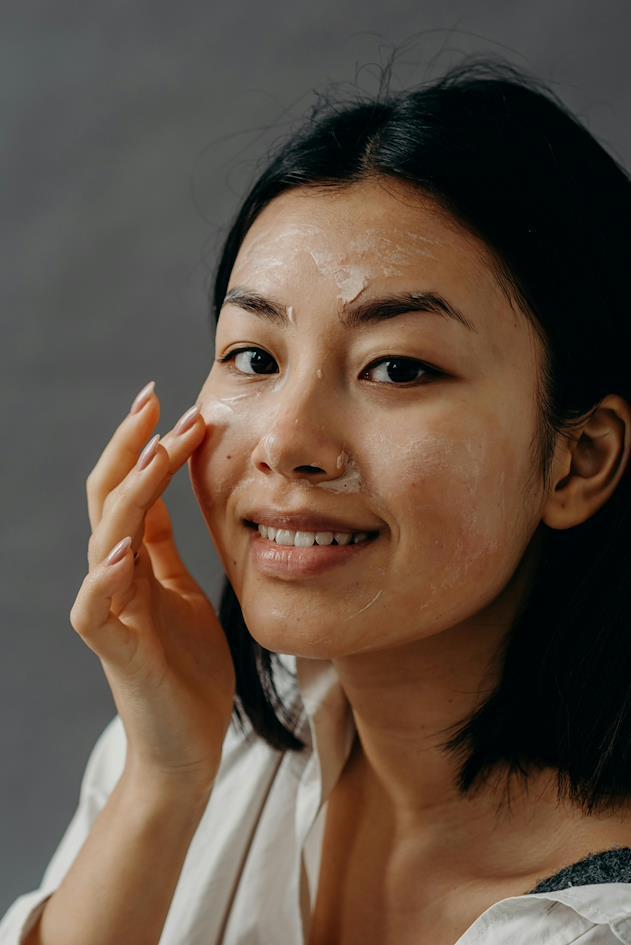 A woman exfoliating her face