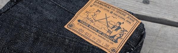 A close up of the tag on the back of jeans for samurai denim